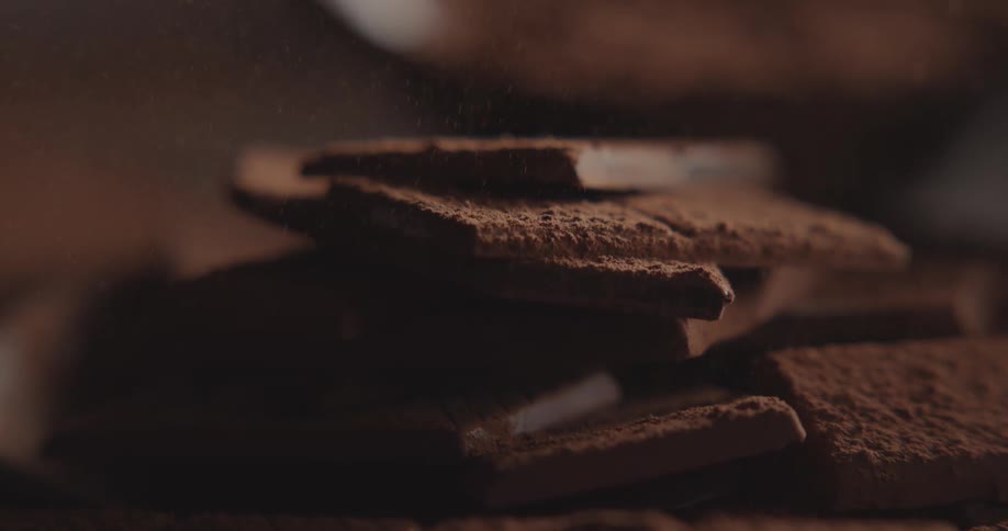 Cocoa powder is dusted onto chocolate bars