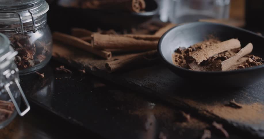 Cinnamon sticks and cocoa powder on a kitchen counter