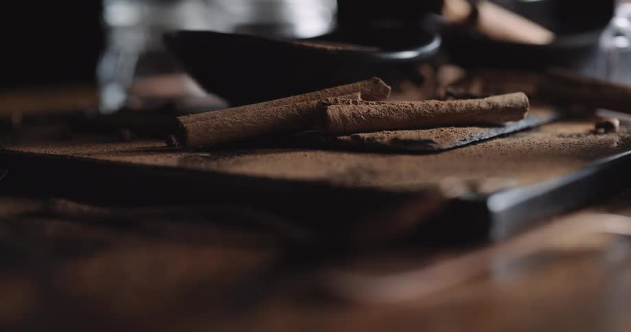 Closeup of cinnamon sticks and powder on table
