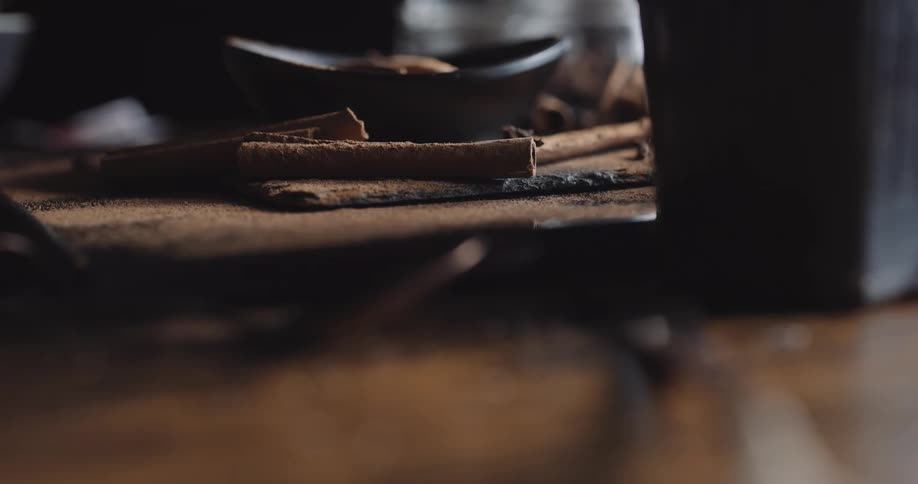 Cinnamon sticks and a dish on a countertop