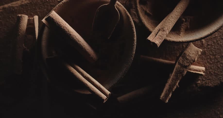 Cinnamon sticks rest in small bowls