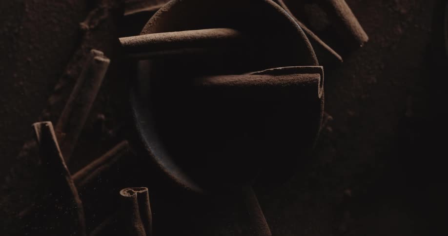 Closeup of cinnamon sticks in bowl and powder