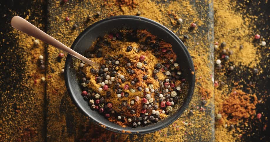Spices are dropped into the bowl of food