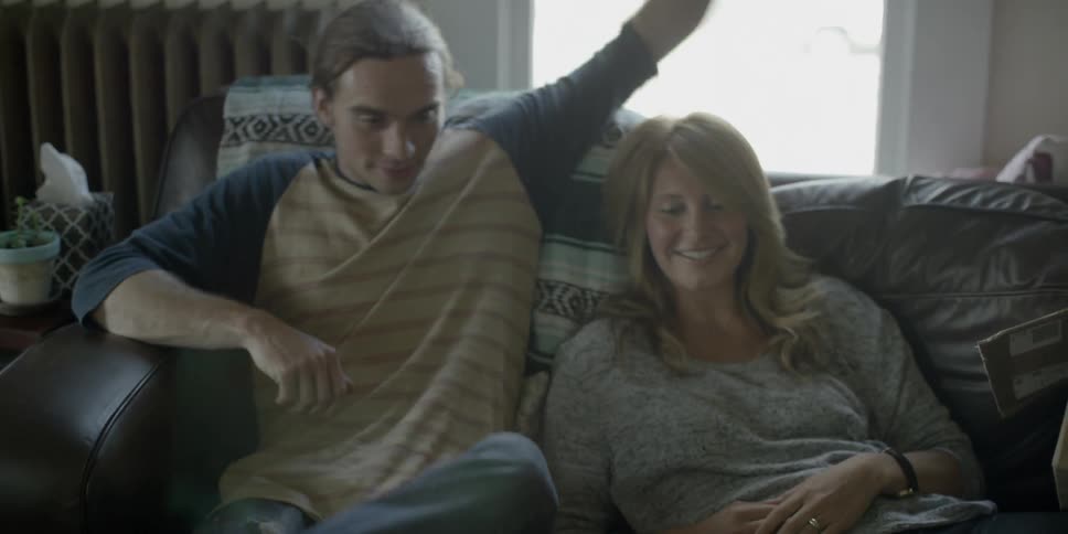 A man sits next to a woman on a couch