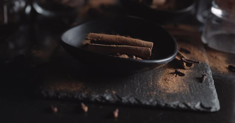 Cinnamon sticks in a dish on a countertop