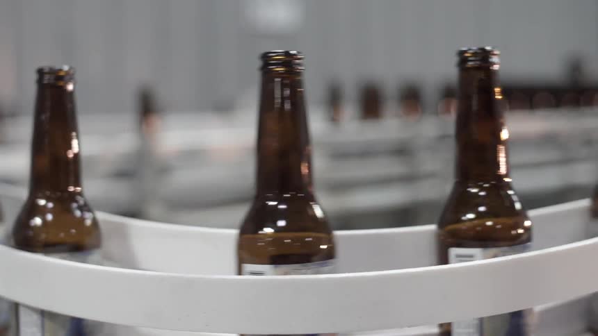 Bottles move along a conveyor belt