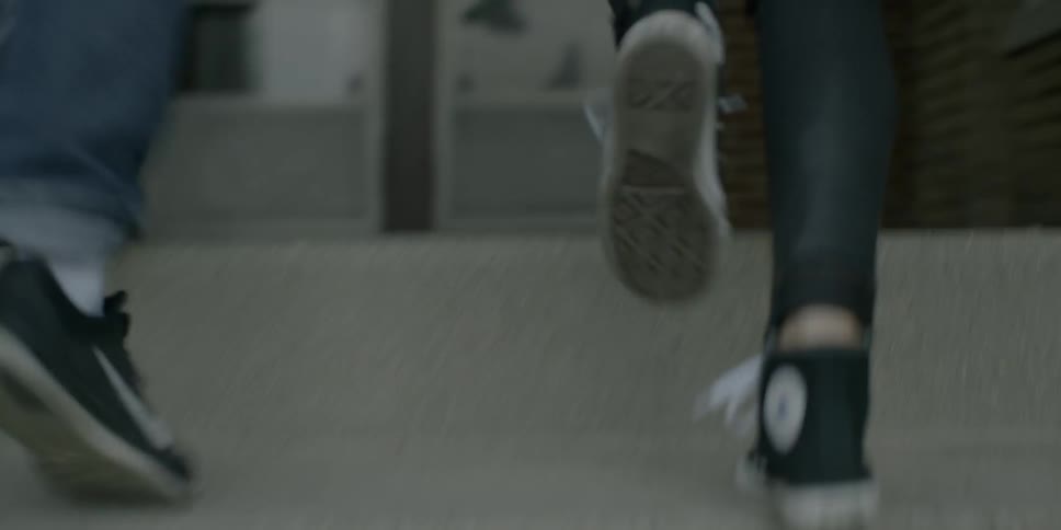 Two people walk over to a door