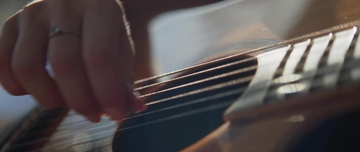 A person is strumming the guitar