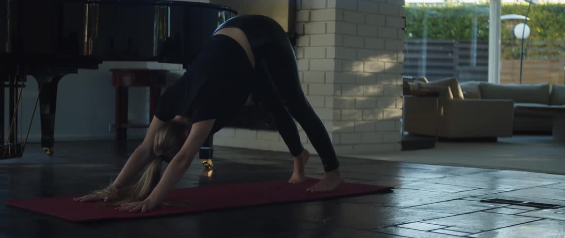A woman is doing yoga indoors during the spring time