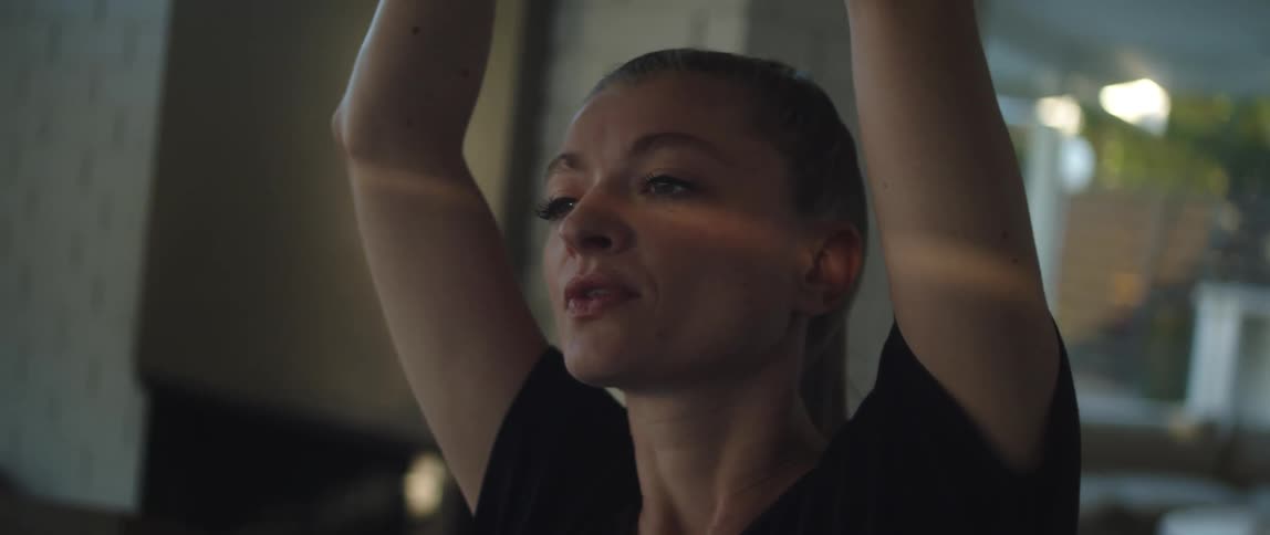 A woman is stretching from left to right with a yoga exercise