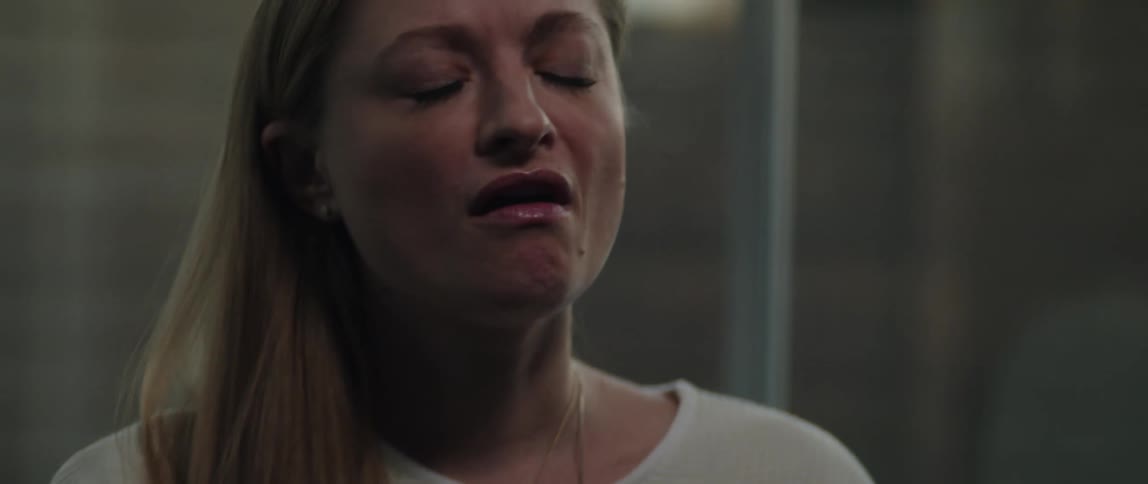 A female up close singing in a room
