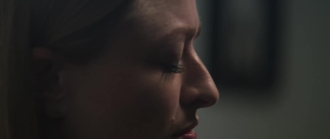 Side profile of womans face with eyes closed playing a grand piano