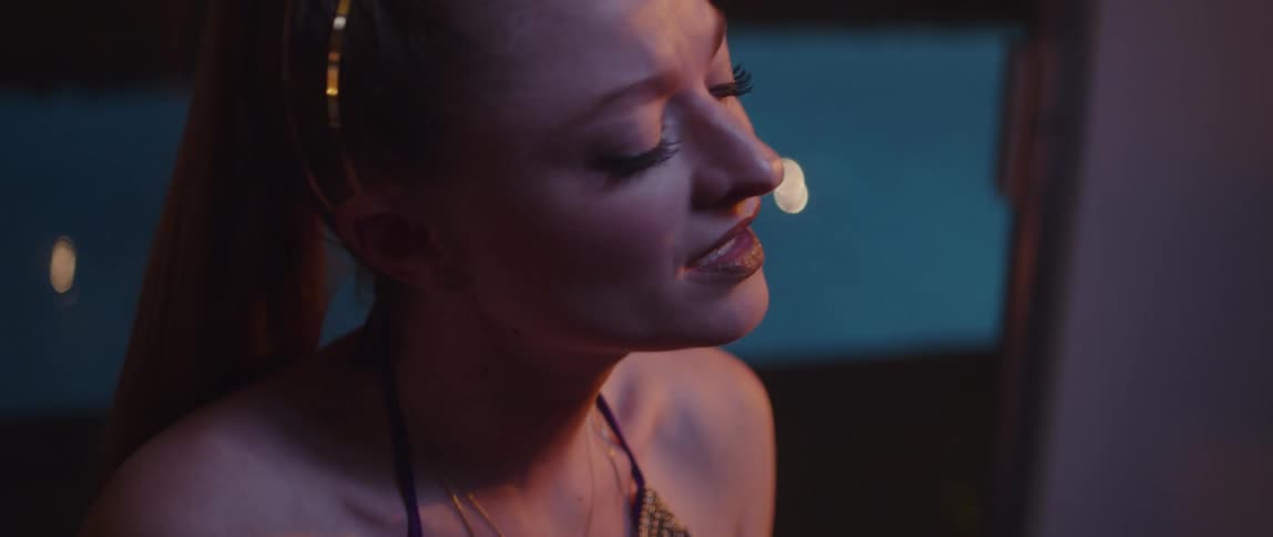 A close up of a woman singing with her eyes closed