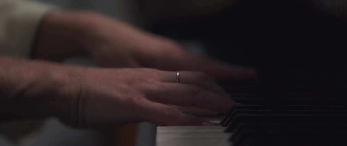 Woman plays piano keyboard