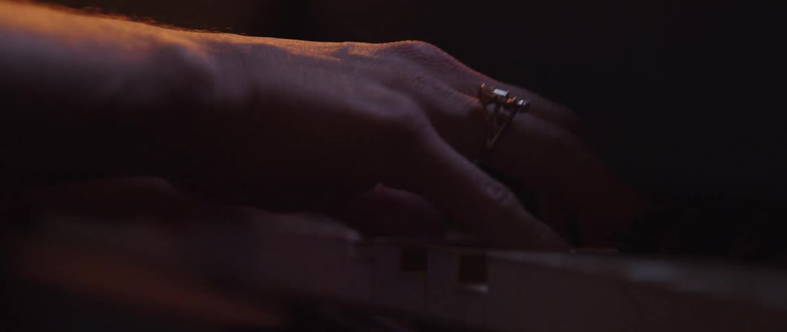 Someone is playing the piano inside of their own home