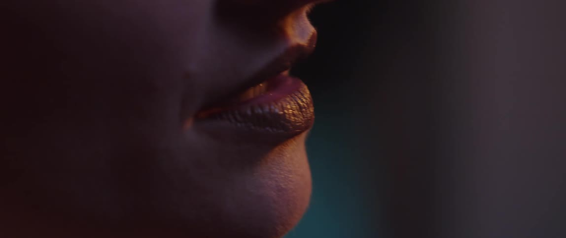A woman is singing with red lipstick