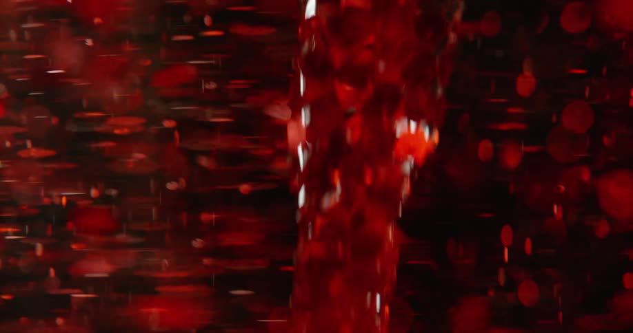 Glowing red dots are moving and reflecting as they move around a whirling object in the darkness
