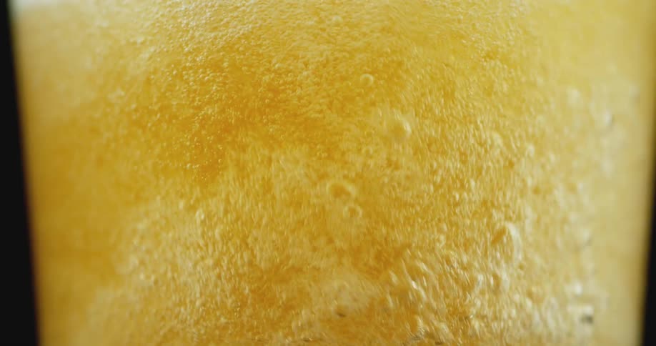 A liquid beverage is being poured into a glass