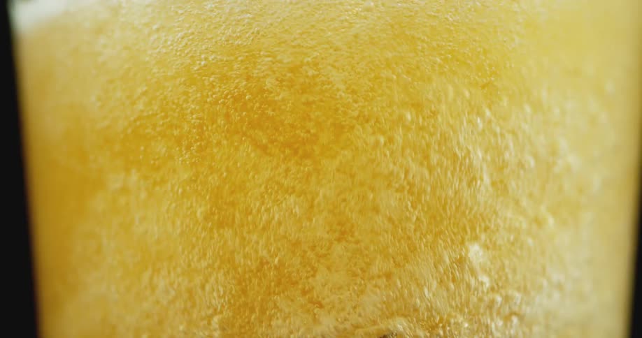 Liquid beer is being poured into a glass