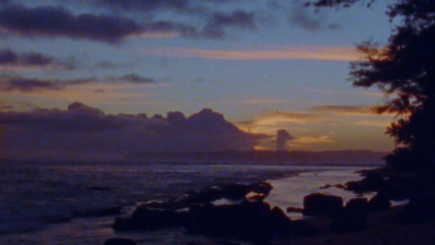 The sun is setting in the horizon of the ocean coast