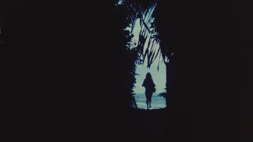 A woman is running towards the beach