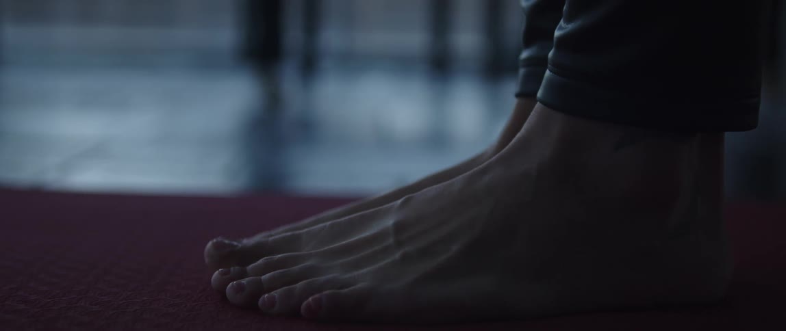 A woman stretches her feet and toes out