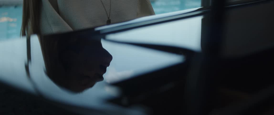 Reflection of the silhouette of a woman playing the piano at home