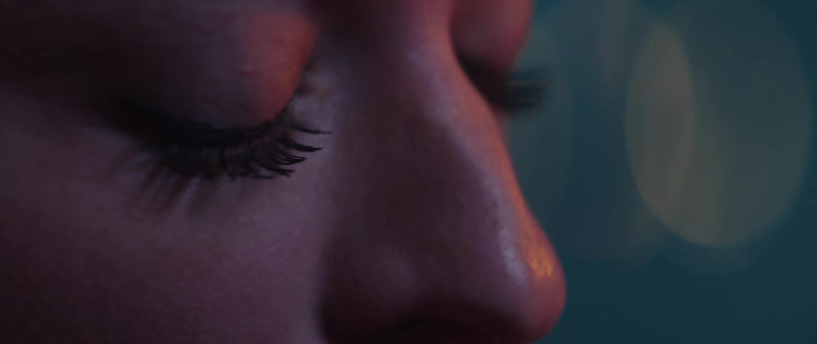 Close up view of a womans face is displayed