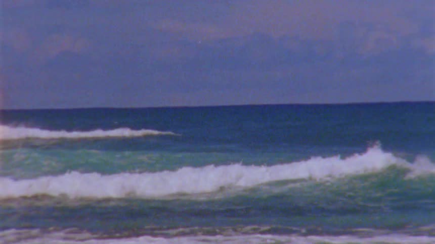 Ocean waves are moving towards the coast at dusk