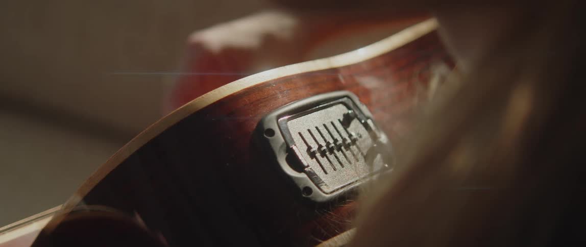 Close up view of a woman playing a guitar