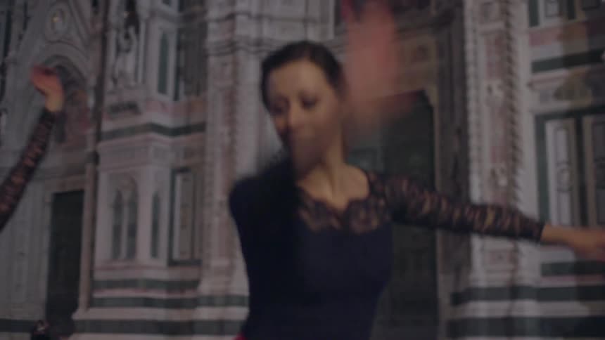 Women are dancing outside together
