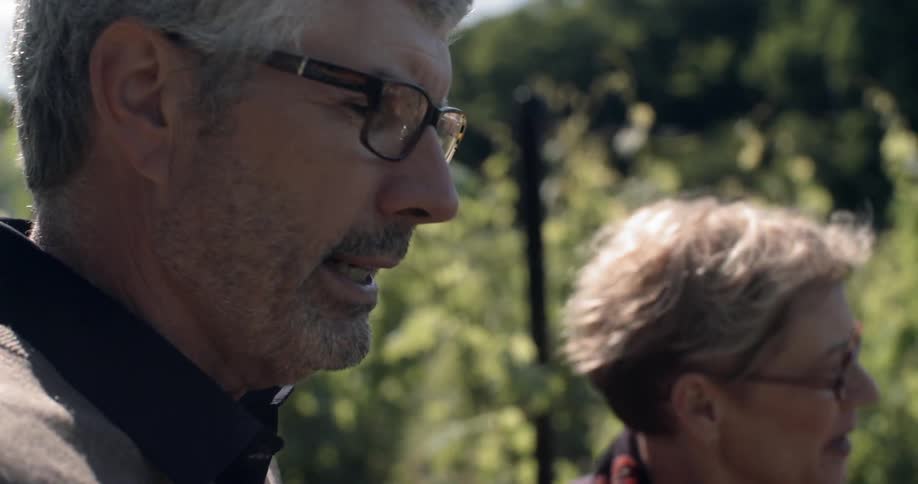 A man and woman talk outside
