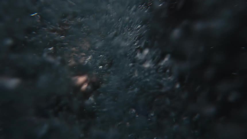 A man struggles to breathe as he flails underwater