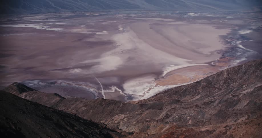Sandy plain fills area between mountains on misty day
