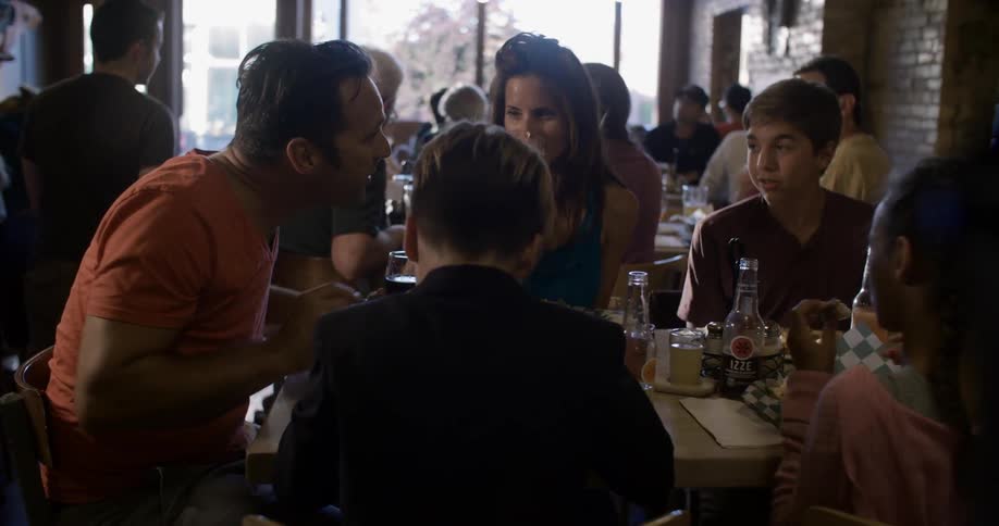 A restaurant is full of people talking eating and drinking