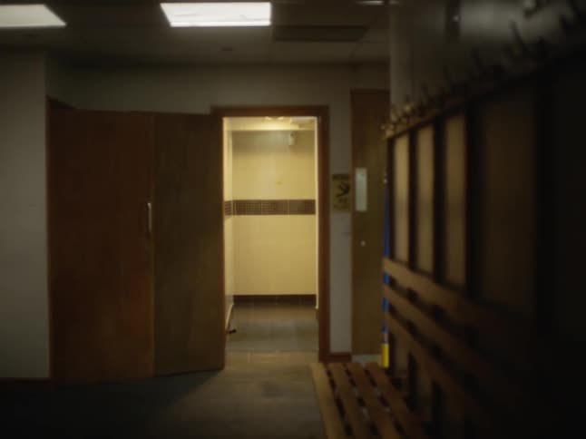 An interior hotel door is propped open to a hallway