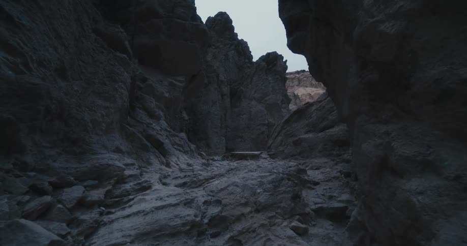 Walking on a canyon in the desert surrounded by rock cliffs at morning