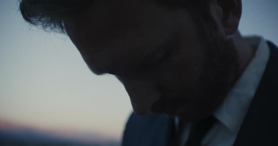 A man is leaning his head forward
