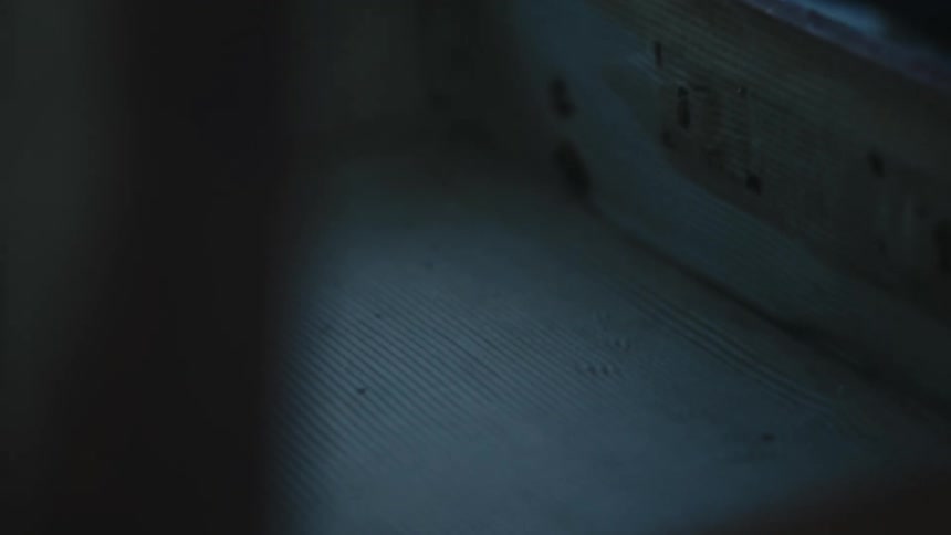 Close up of the empty interior of a briefcase inside a dimly lit room
