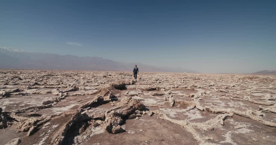 The man is walking in the desert