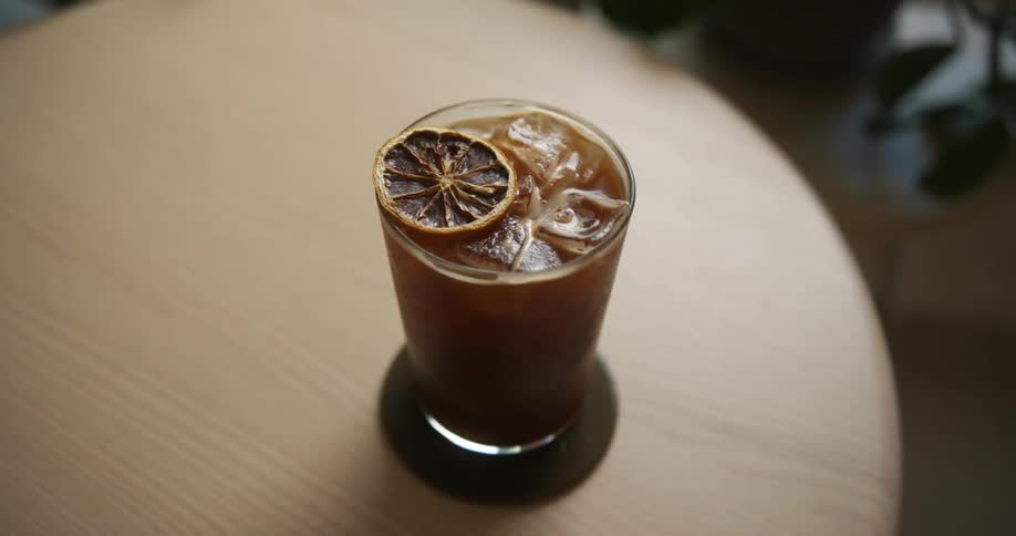 An iced drink sitting on a wooden table