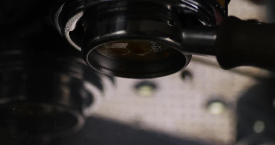 Coffee flows from commercial grade coffee making machine into metal container