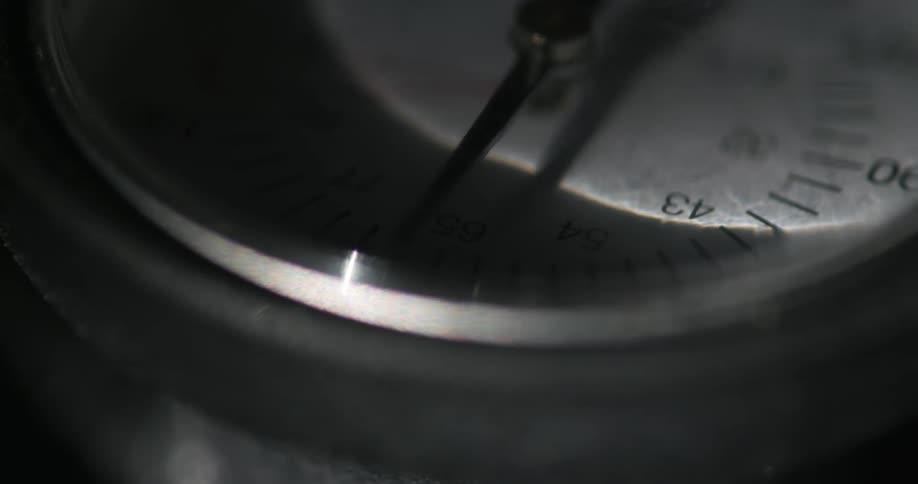 Close up of the dial of a wristwatch inside a dimly lit room