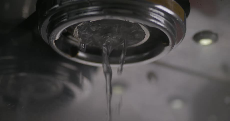 A person makes a drink using an espresso machine