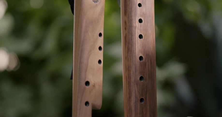 Close up of hand made wooden wind musical instruments outdoors