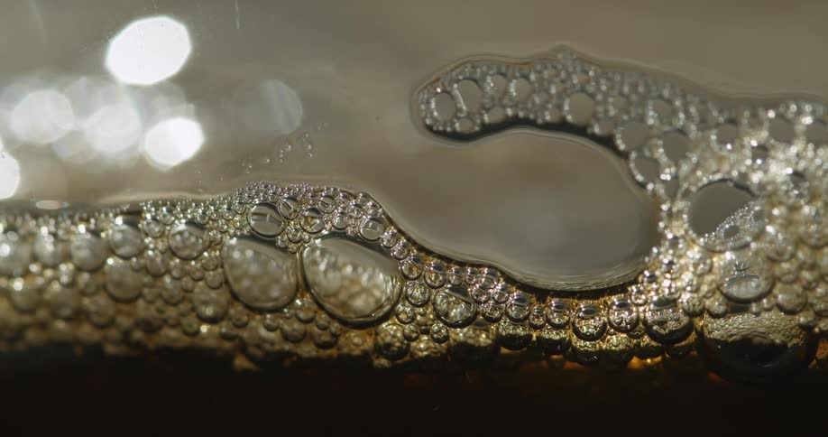 A liquid solution with shades of brown and bubbles