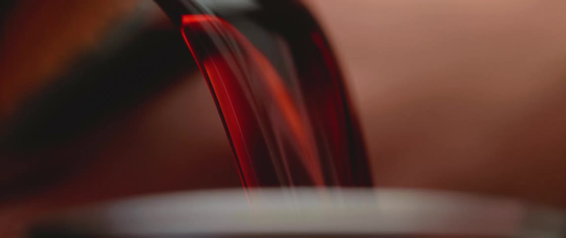 Red wine being poured into a glass