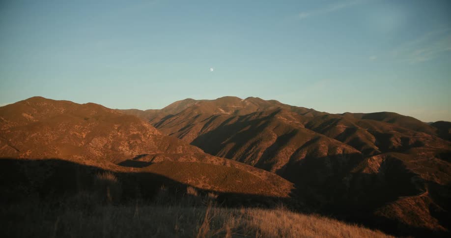 A mountainous countryside under a clear daytime sky