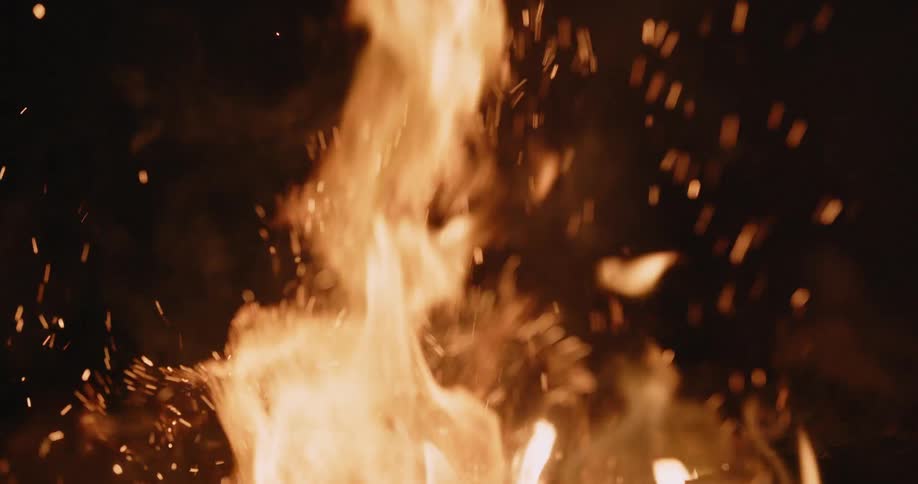 A fire sends embers and sparks into the air
