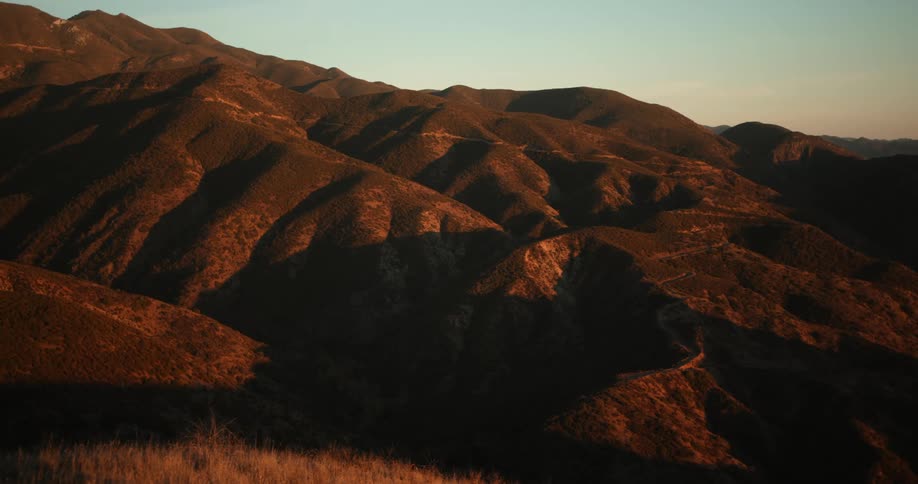 Landscape of barren mountain range at sunset
